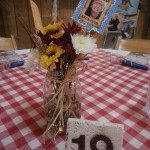 Wildflowers in mason jars. Table numbers made from tiles